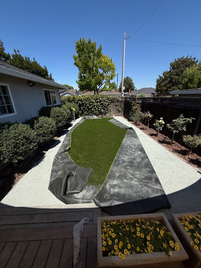 Step 4: Turf roll-out and securing — Deluxe Building Services
